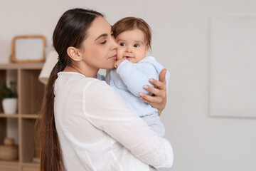 Young mother hugging her baby at home. International Hug Day
