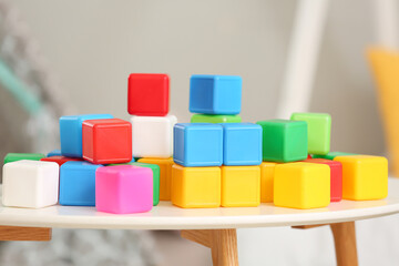 Colorful cubes on table in children's bedroom, closeup