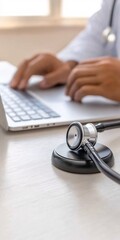 Doctor using laptop computer with stethoscope nearby Medical healthcare professional technology