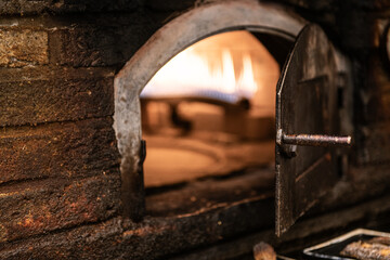 putting a fire in the oven before making food.