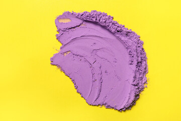 Violet powder pigment on yellow background