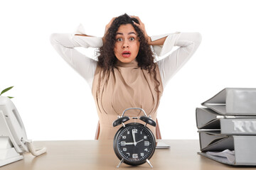 Stressed African-American businesswoman at table on white background. Time management concept