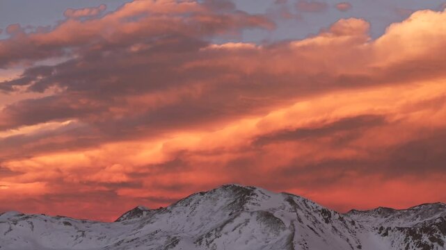 Last light winter solstice December Rocky Mountains golden hour aerial drone Colorado Continental Divide Loveland Pass Herman Gulch Coon Hill vibrant sunset dusk rugged snowy peaks pan down and up