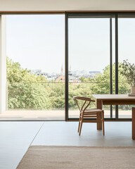 Fototapeta premium Modern interior design featuring large windows and a scenic view of the city