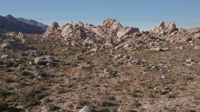 Kelso Pinto Basin Dunes Joshua Tree National Park California aerial drone Yucca Trees San Fernando County Mojave Colorado desert blue sky rugged hill rock formation sunny afternoon forward upward