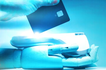 Credit card payment with Robot's hand holding credit card terminal