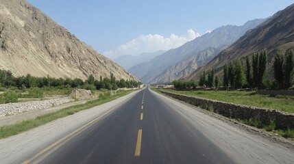 Fototapeta premium A stunning high-altitude road with panoramic views of sunlit mountain ranges.