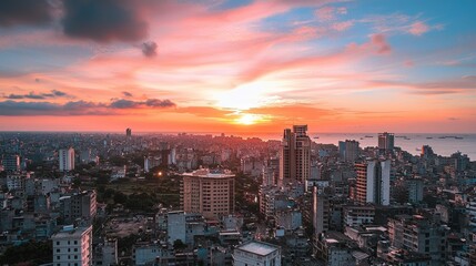 Fototapeta premium Sunset over Chittagong City: A breathtaking panoramic view of the cityscape during a vibrant sunset, showcasing the city's architecture and skyline.