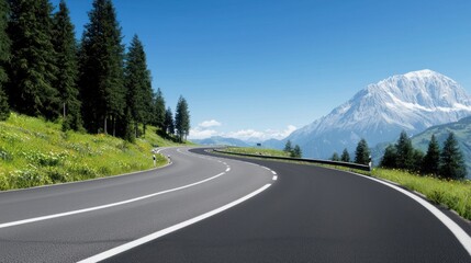 Fototapeta premium Scenic winding road through lush greenery and mountains.