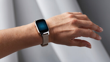 Modern smartwatch on wrist showcasing sleek design and display in a stylish indoor setting