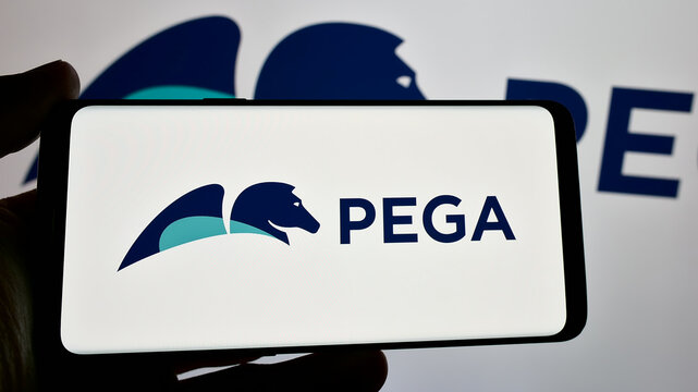 Stuttgart, Germany - 12-11-2024: Person holding smartphone with logo of US software company Pegasystems Inc. (Pega) on screen. Focus on phone display.