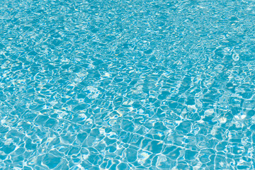 Obraz premium Spa resort on summer vacation. Pool side resort with pool water surface background. Sea ripples on blue pool background. Sea background. Swimming pool rippled. Summer vacation