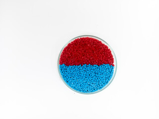 plastic masterbatch, masterbatch granules, polymer carrying pigment poured into a glass cup forming...