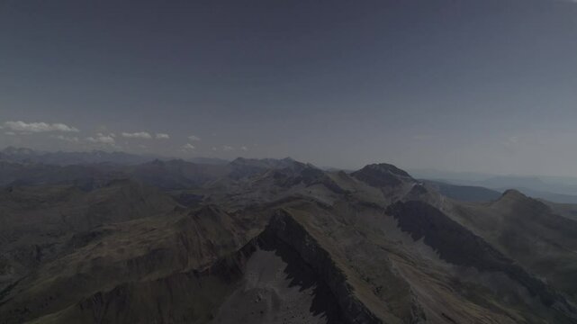 This drone video features a stunning descriptive reverse shot, flying away from the imposing Pico del Castillo d&rsquo;Acher in the Aragonese Pyrenees, Spain, revealing its breathtaking mountain landscapes.