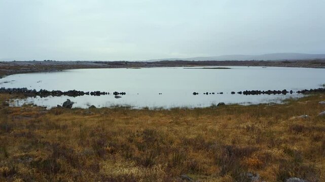 Aerial dolly gliding towards the Turlough at Mullaghmore. Burren, County Clare