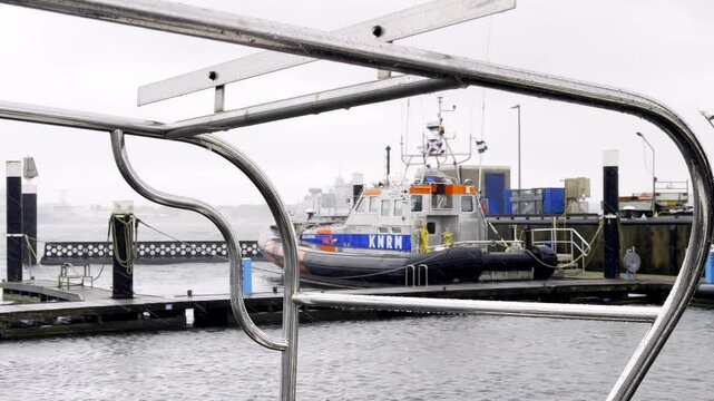 Guardian of the North Sea KNRM Lifeboat Stands Ready at a Dutch Harbor, a Symbol of Safety and Hope on a Stormy Day