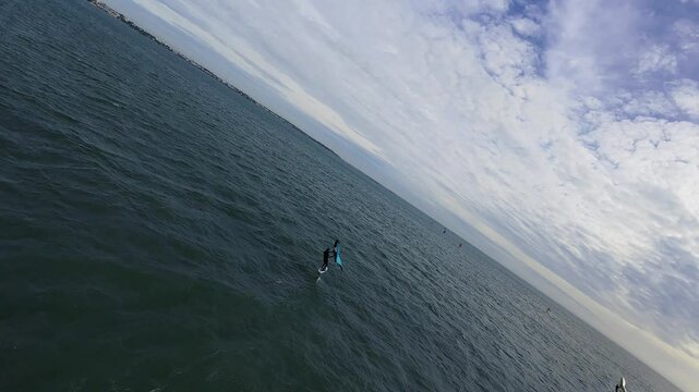 Aerial footage from FPV drone, kitesurfers in the sea at a spot. 