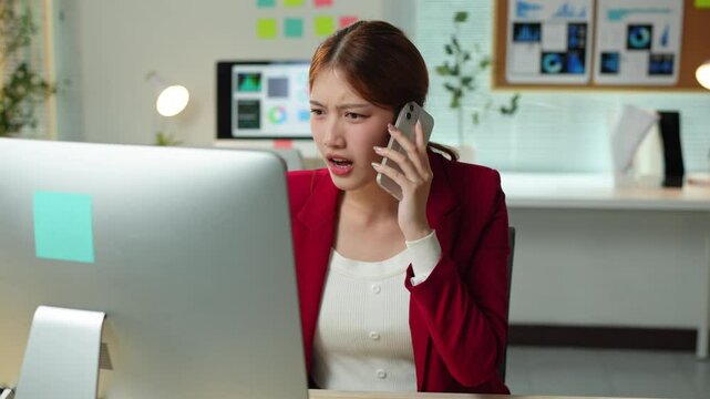 Office worker receiving a phone call and reacting with surprise, looking at her smartphone, getting angry during the call, and finally getting stressed and holding her head in her hands