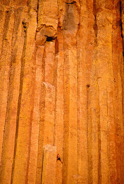 Solo rock climber free climbs Devols Tower in Wyoming.