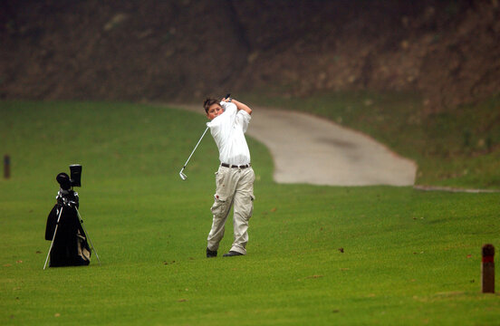 13 year old teen plays in a junior golf tournament.