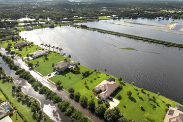 Flooded houses from hurricane rainfall water in Florida residential community. Aftermath of natural...