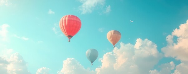 Obraz premium Colorful hot air balloons floating in a clear blue sky with fluffy clouds