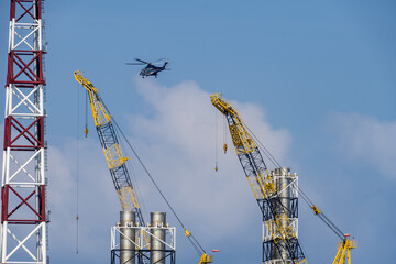 A helicopter about to land on an oil production platform for transferring of offshore crew at oil field