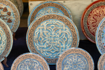 A collection of blue and white plates with designs on them. The plates are arranged in a row and are of various sizes