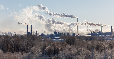A large industrial area with smoke and steam coming out of the factories