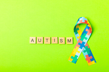 Autism ribbon. Autism awareness day. World autism awareness day with puzzle pattern ribbon on textured background. Colorful puzzle ribbon. Medicine concept. Space for text. Copy space