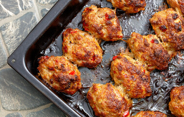 A tray of meatballs is sitting on a counter