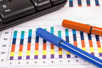 Ballpen, computer keyboard and financial chart showing production or sales statistics. Business