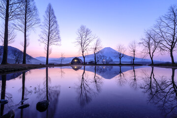 Fuji Mountain reflection water in front in Winter at morning sunrise scene view, location and landmark of Fumotoppara Campground, japan