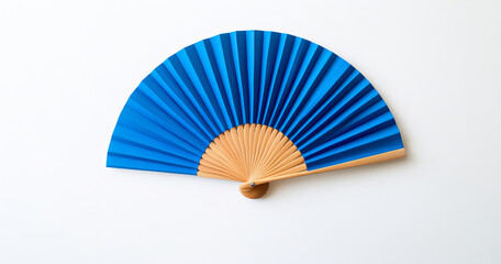 A delicate blue fan adorned with floral patterns and a wooden handle rests on a white background. Its intricate fabric design and bright colors create an elegant, timeless aesthetic.