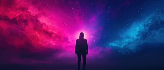 Fototapeta premium A silhouette of a figure stands against a vibrant cosmic backdrop of purple and blue hues, evoking a sense of wonder and exploration.