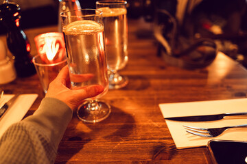 A Hand Holding a Glass of Lemon Water