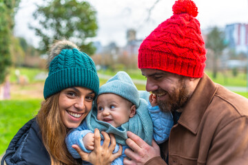 Happy family enjoying a day at the park in winter