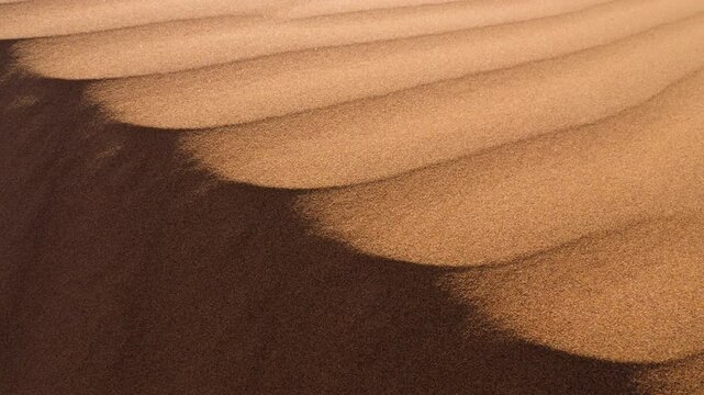 Closeup of beautiful abstract sand dune patterns. Sahara desert, Mhamid, Erg Lihoudi, Morocco. 4k footage. 
