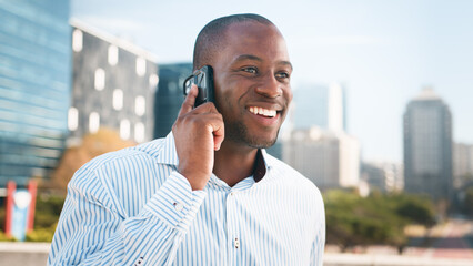 Cheerful Businessman Talking on Phone Outdoors in a Modern Urban Setting
