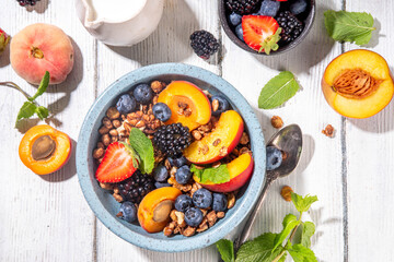 Granola breakfast with fruit and berry