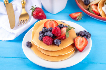 Stack of traditional american pancakes with summer berries