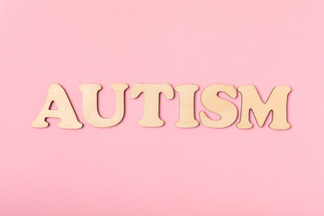 Autism awareness day.2 April world autism awareness day background.Design element.Care Awareness campaign for Autism.AUTISM text with colorful wooden puzzles, letters and cubes.Space for text.Top view