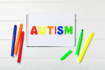 Autism awareness day.2 April world autism awareness day background.Design element.Care Awareness campaign for Autism.AUTISM text with colorful wooden puzzles, letters and cubes.Space for text.Top view