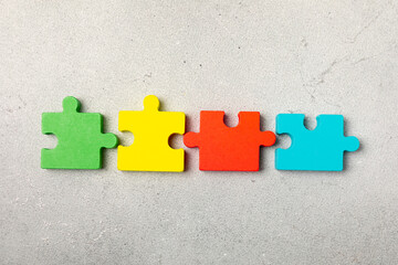 Obraz premium Autism puzzle.Autism awareness day. Colorful bright puzzles.Puzzle. 2 April world autism awareness day background. Top view. Space for text.Copy space.Design element.Care Awareness campaign for Autism