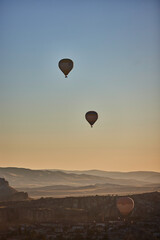 Fototapeta premium Balloons lifted into the air in Cappadocia. Entertainment and tourist attraction. A spectacular sight