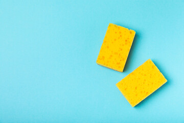 Colorful dish sponges on textured background. Kitchen sponge. Cleaning concept, cleaning service. Dishwashing liquid with clean and dirty dishes plate. Place for text, copy space. Wash the dishes.