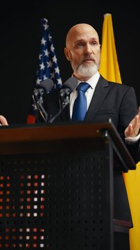 Male government official addresses the audience at an international summit