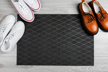 Doormat. Welcome mat on the floor background. Women's shoes on a doormat on background. Interior decor element in the hallway. Close-up. Space for text. Copy space.rug near the door in the hallway.