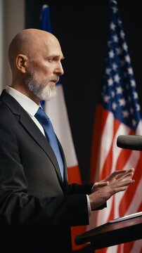 U.S. male diplomat speaks at an international summit, discussing global affairs