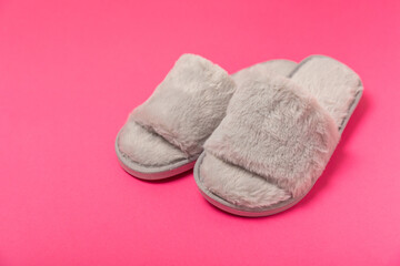 Soft slippers on a bright colored background, close-up. House slippers. Comfortable shoes for home. Foot care concept. Home comfort. Space for text. Copy space.